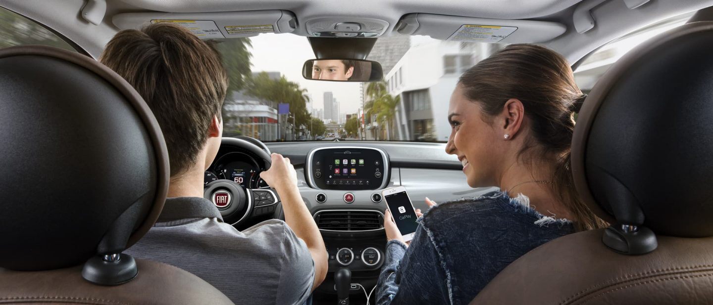 A couple in the front seat of the 2020 Fiat 500X presented from the rear seat.